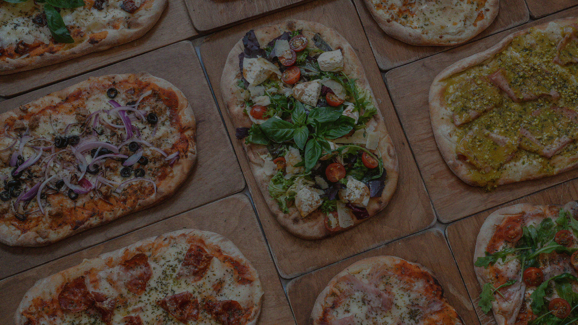Pizza Gio sticker set and logo over an overhead spread of pizzas